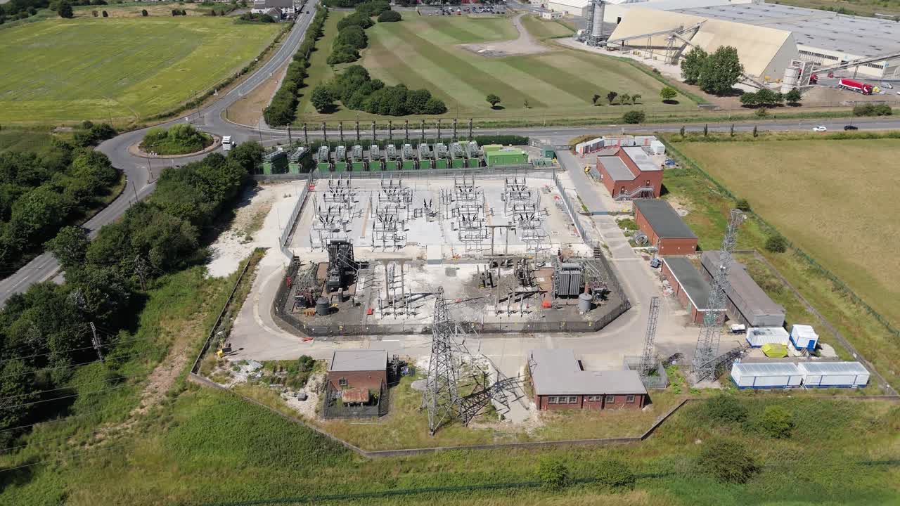 Aerial drone view of substation with transformers, pylons and powerlines generating electrical energy in Immingham England UK Europe