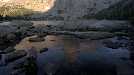 beautiful view of cirque of the towers with rocky mountain peaks and a serene river running through, reflection in water