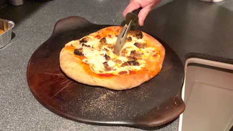 pizza, cut, homemade, slicing, cutting, italian, dinner, hot, fresh, cooked, meal, circle, ready, stone, corn meal, slice of pizza, preparation, meat, cook, traditional, kitchen, italian food, closeup, hand, table, cooking, pie, cuisine, top view, gourmet