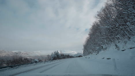 POV-video-of-driving-through-Norway's-Western-Fjords-in-winter,-showcasing-a-journey-along-snowy-roads