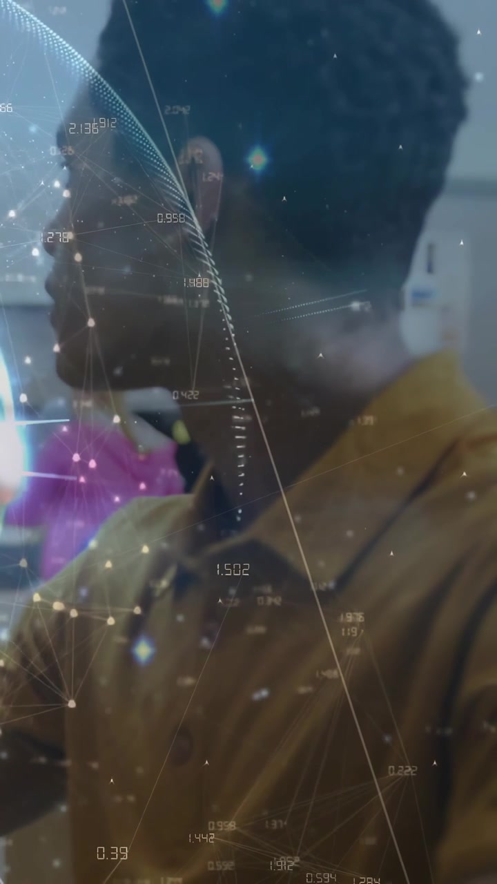 Male student in lab turning into right profile after arm reach, globe overlay layering