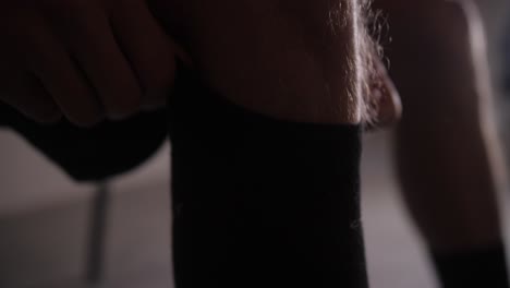 cinematic slow motion shot, footballer pulls socks up to his knees above shins