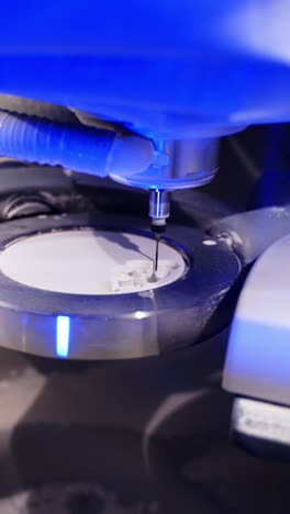 Dentistry. Dental milling machine working creating implants and human teeth carving out of ceramics. Industrial revolution. Technologies. Vertical video