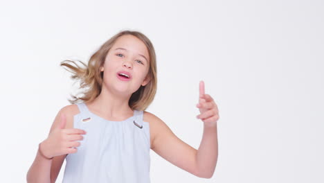 young girl dancing against white background in slow motion