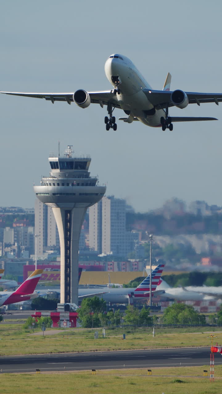 MADRID, SPAIN - APRIL 1, 2025: An Iberia Airbus A320 lifts off from the runway at Adolfo Suarez Madrid-Barajas Airport. Vertical footage