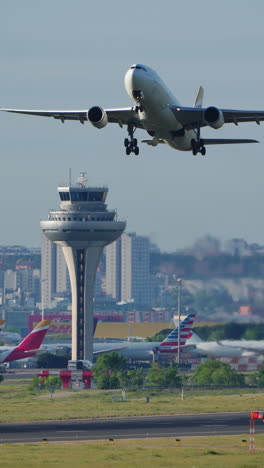 madrid, spain - april 1, 2025: an iberia airbus a320 lifts off from the runway at adolfo suarez madrid-barajas airport. vertical footage
