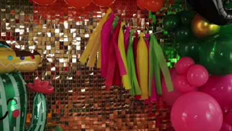 cinco de mayo themed decoration surrounded by balloons and golden backdrop