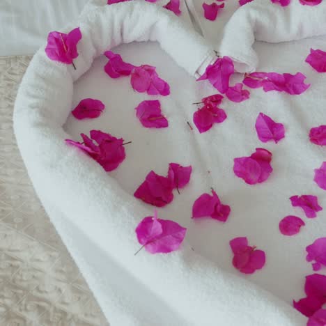 heart made of towels with flower petals