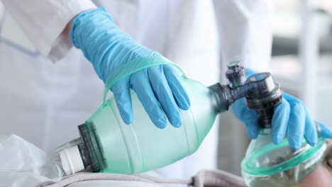 medical professional administering oxygen to a patient with a manual resuscitator