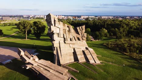 memorial of the victims of nazism at the ninth fort of kaunas city, lithuania in flying around drone aerial shot with kaunas city in the distance