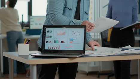 closeup of laptop screen with enterprise resource planning showing moving charts and growing turnover