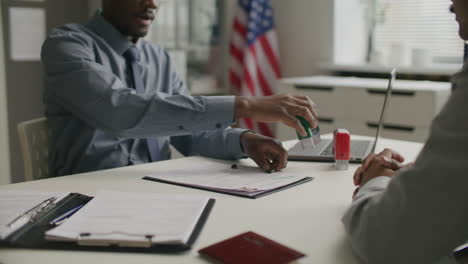 Consular Officer Shaking Hands with Applicant after Visa Approval
