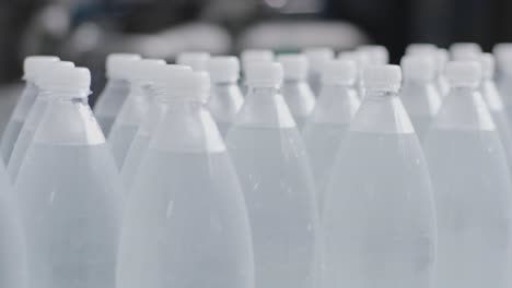 conveyor belt with bottles of drinking water at a modern beverage plant