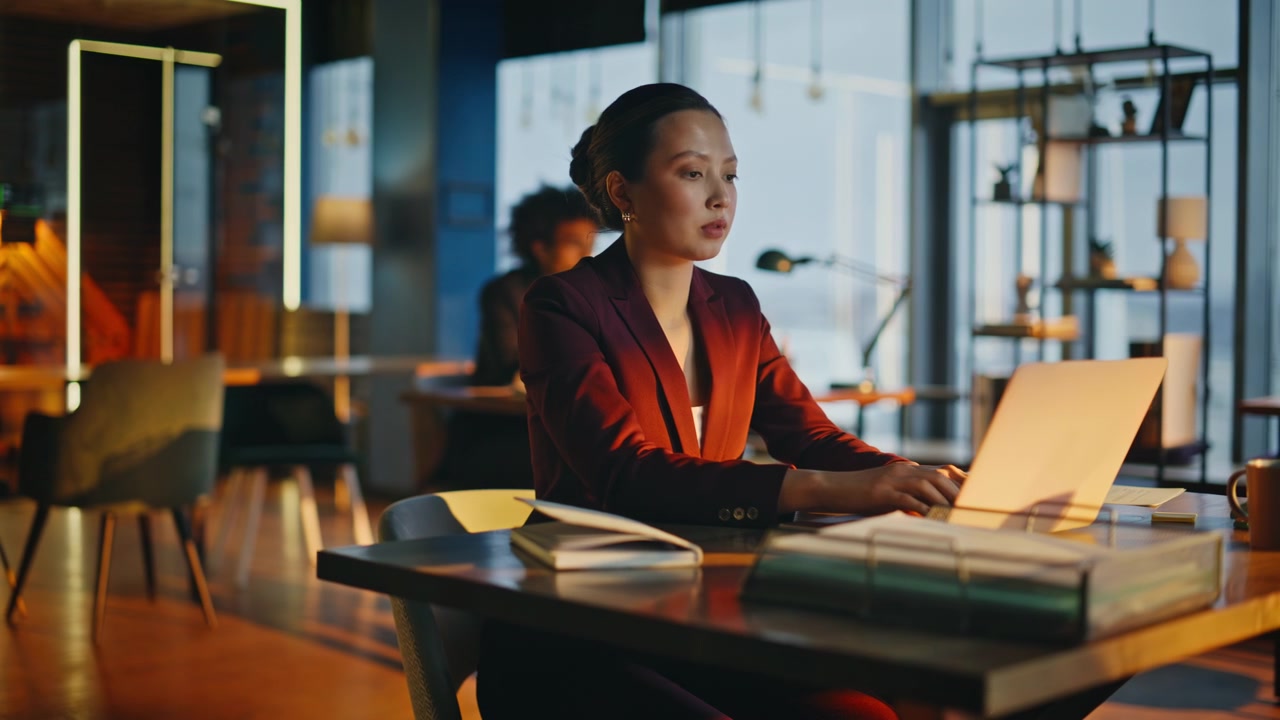 Businesswoman typing laptop modern coworking office. Camera push evening work.