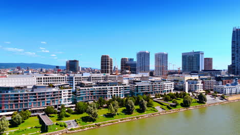 bratislava river skyline. a vibrant view of bratislava highlights modern buildings by the river, reflecting the city's urban lifestyle