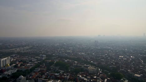 surabaya's bustling cityscape from above in this drone footage, revealing its dense population and the concerning issue of severe air pollution
