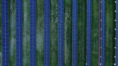 Flying-Above-Industrial-Area-Showcasing-Massive-Solar-Panels-Installation