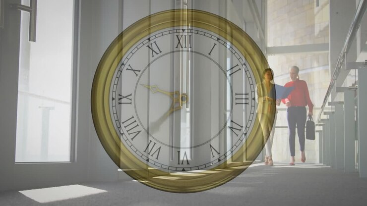 Animation of moving clock over diverse colleagues walking and discussing work in office