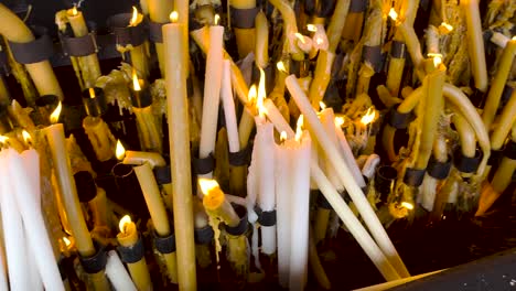 close up gimbal shot of candle offering in sanctuary of fatima, portugal