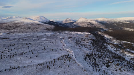 stunning aerial footage of fish lake and its snow-covered surroundings in whitehorse, yukon. the wintery landscape, frozen lake, and distant mountains offer an unforgettable winter scene.