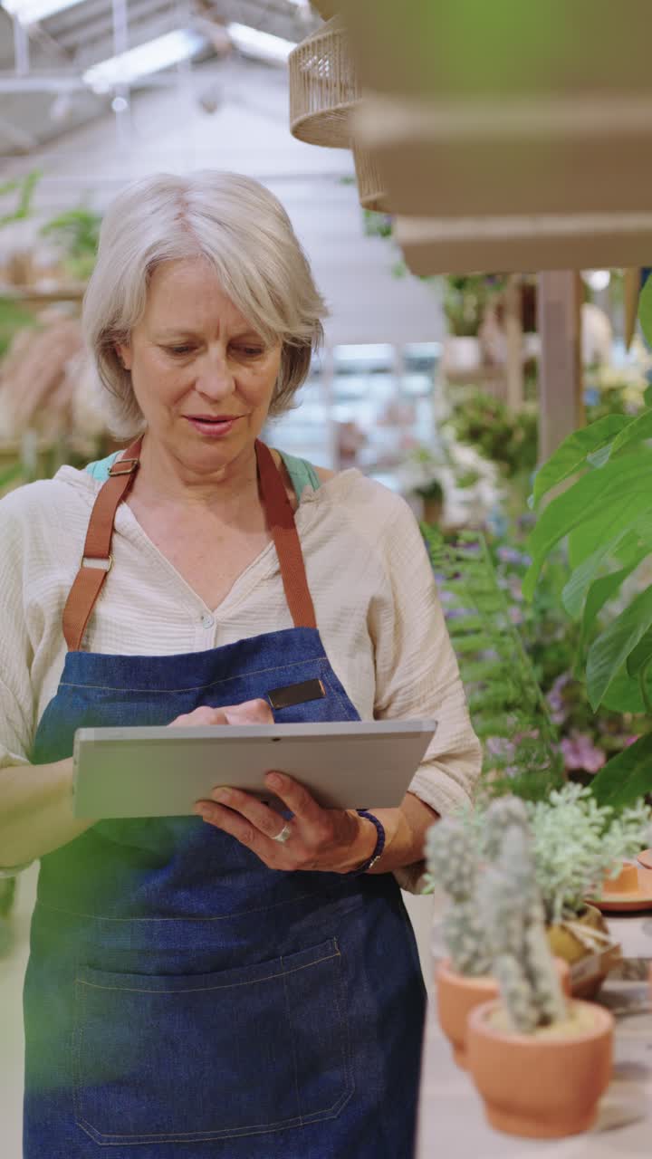 Woman using tablet in greenhouse