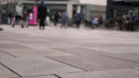 busy high street shopping mall defocused wide tilting shot