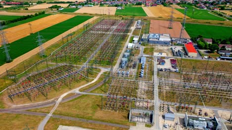 electricity generating voltage poles, transmission and substation - aerial drone shot