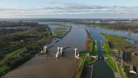 Hagestein dam and lock complex as flood water builds up in Lek river, aerial