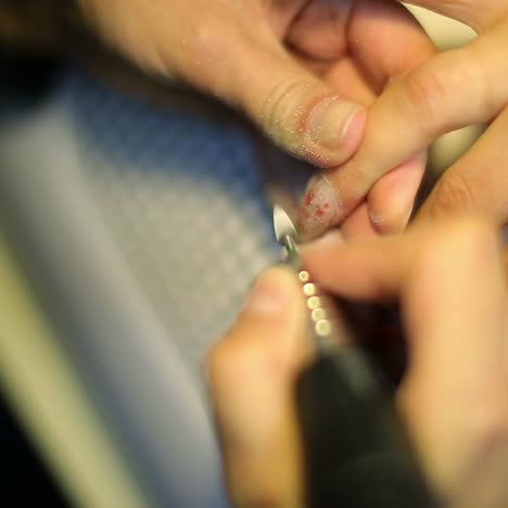 una mujer haciendo una manicura de uñas.