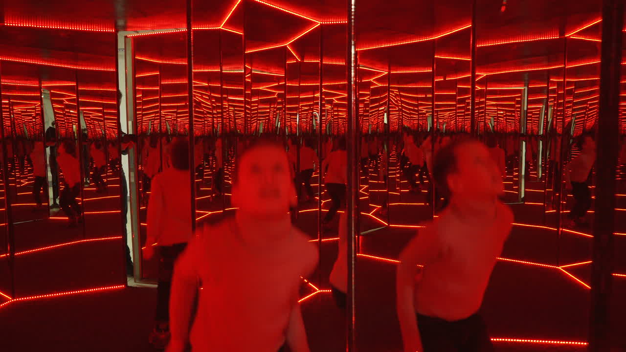 Boy playing with distorted mirror. Museum of entertaining sciences