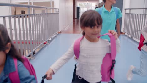 diverse group of schoolkids of different ages running on the hallway, among lockers