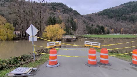 Broken Bridge Caused By Extreme Rainfall In Abbotsford Closed With Yellow Caution Tape And Traffic Drums