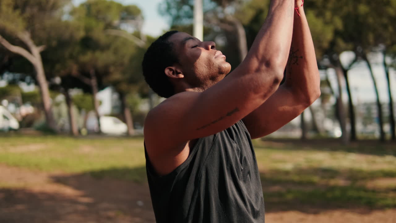 Young Man Meditates in the Park