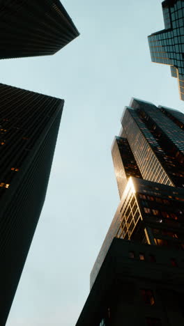 looking up at tall buildings in a city