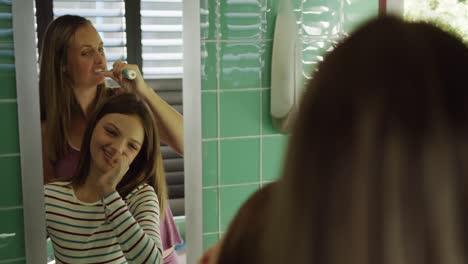 Mother-and-daughter-brushing-their-teeth-together