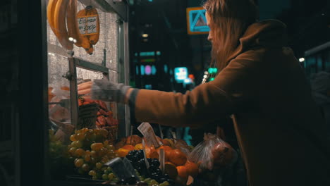 Young-woman-buys-products-in-the-stall-outside