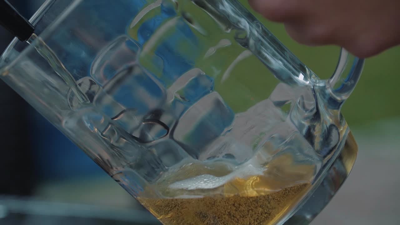 Un ragazzo versa birra in un boccale dalla spina
