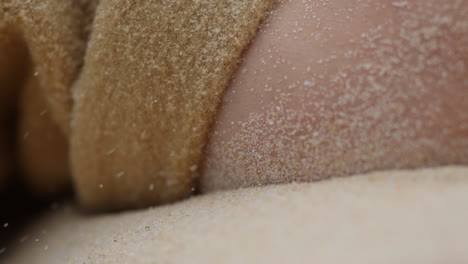 extreme close up of desert sand storm , male wearing a robe laying down protecting and survival experience