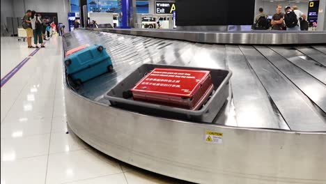 suitcases rotating on baggage claim conveyor belt