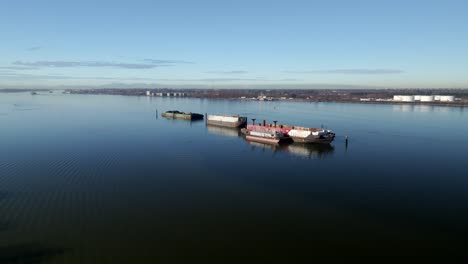 old rusty barge vessel docked in fraser river in bc, canada. drone approach