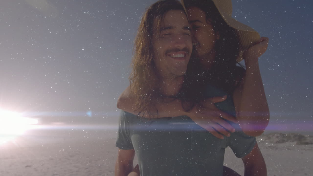 man carrying woman piggyback on beach sunset showing technology overlays with heart icon and chart