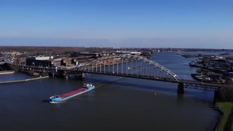 Marine-Vessel-Sailing-Under-The-Bridge-In-River-Noord-Near-Hendrik-Ido-Ambacht,-South-Holland,-Netherlands