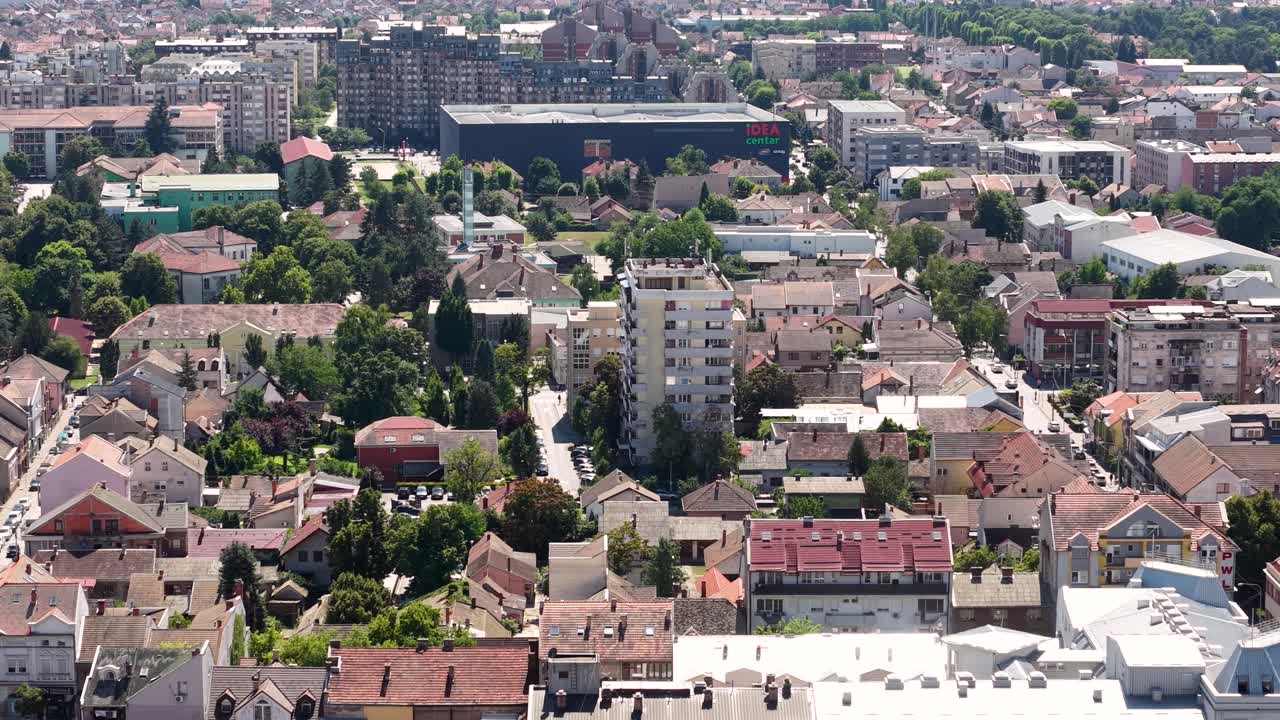 Aerial view of a cityscape with residential buildings and trees