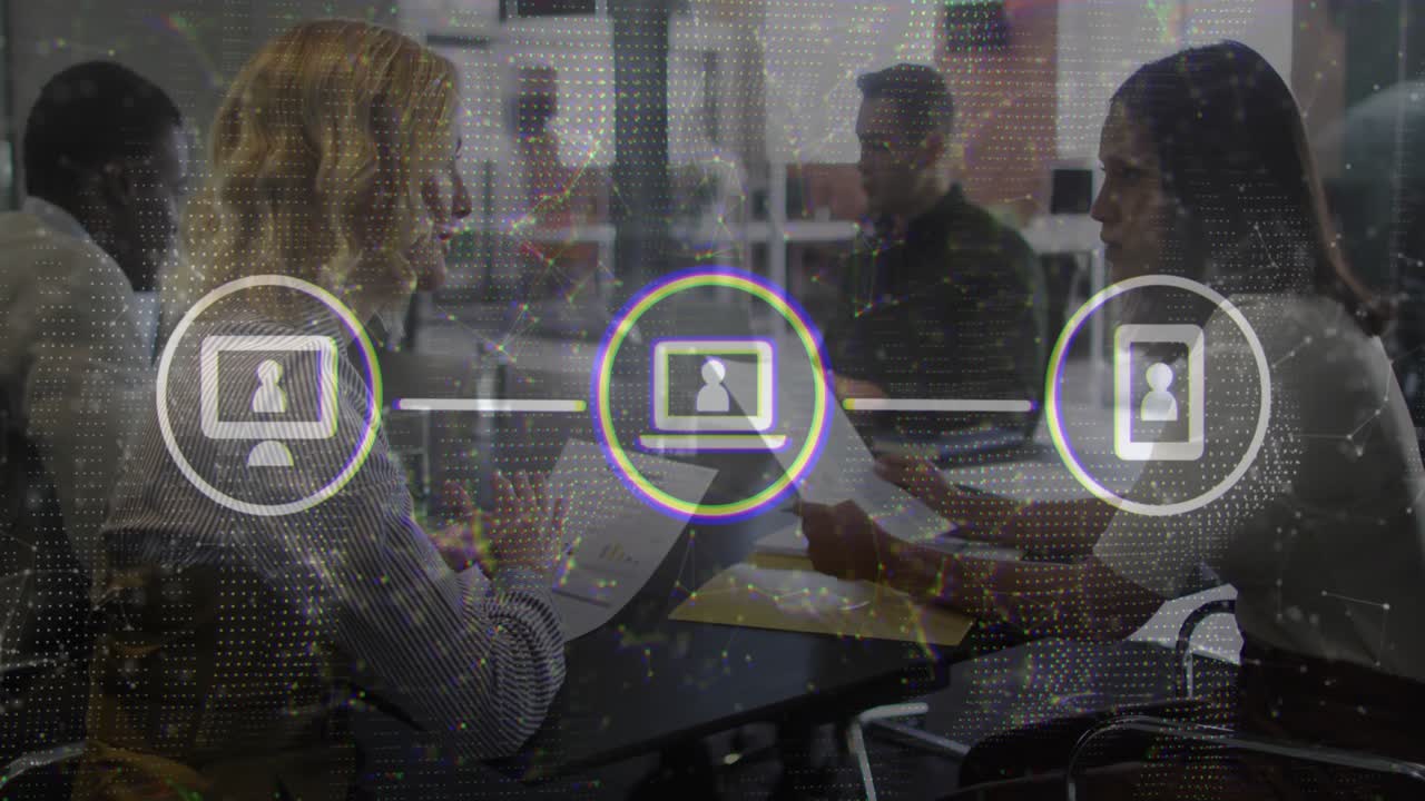 Colleagues reviewing documents at business meeting, showing animated network icons linking devices
