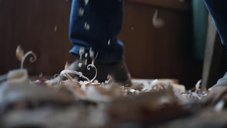wood chips and dust falling below craftsman carving