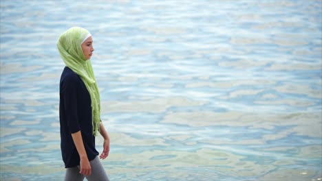woman in hijab at the beach