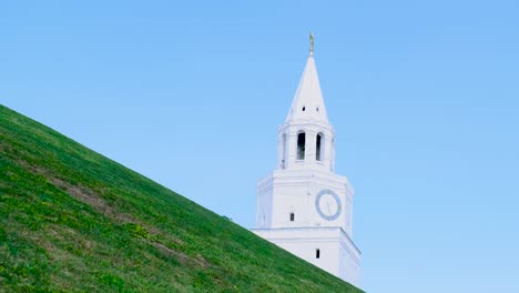 white tower on a grassy hill