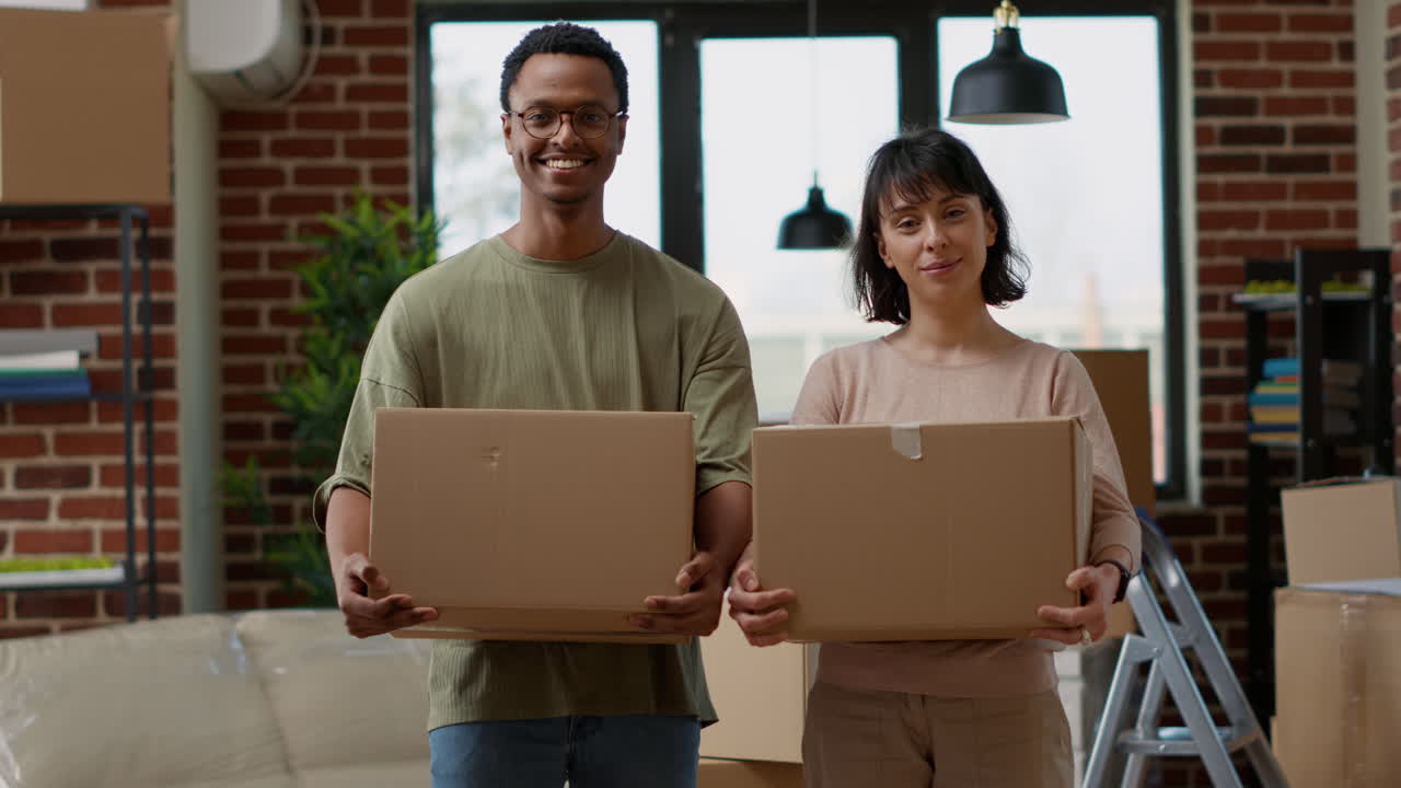 Portrait of cheerful people moving in rented apartment flat
