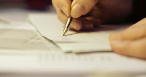 senior businessman writing on paper at table in office 33