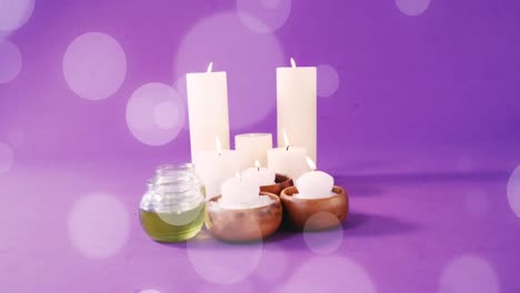 Animation-of-white-light-spots-over-candles-on-purple-background